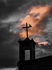 cross at sunset church with beard