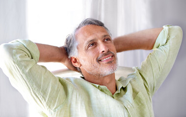 Obraz premium Laid-back. A mature man relaxing at home with his hands behind his head.