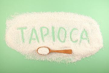 Inscription Tapioca of tapioca pearls. White small sago balls in wooden spoon. Balls use for bubble tea, boba drinks and refreshments cocktails