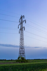 Detail of electric pole with electric cables at sunset