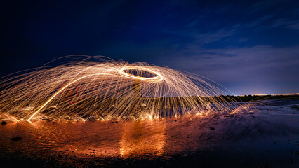 Bar of beautiful vibrant gold and circular wire wool in a long exposure at night in Kuwait