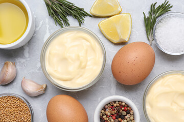 Delicious homemade mayonnaise, spices and ingredients on grey table, flat lay