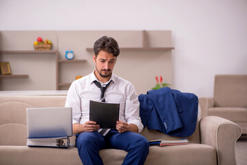 Young male employee working from home during pandemic
