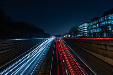 View of the white and red light trails on the night street. Hannover, Lower Saxony, Germany.