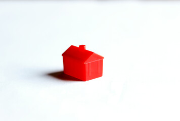 Red toy house on white background with shadow
