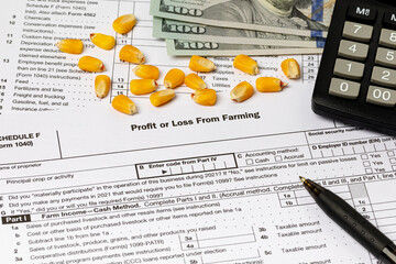 Corn kernels and farm tax form. Farming income, finances and management concept.