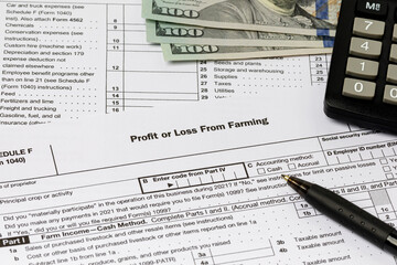 Farm tax form and cash money. Farming income, finances and management concept.