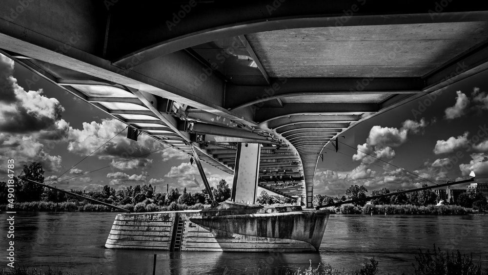 Poster greyscale shot of the under of the bridge and a river