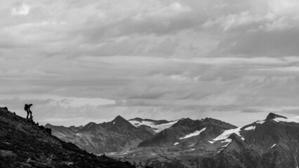 Fototapeta na wymiar Hiker on the ridge, in front of mountains