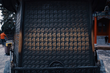 Metalic carved gates with Chinese hieroglyphs outdoors