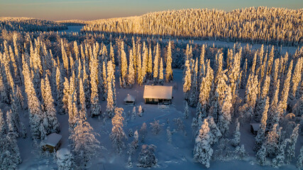cabin in snowy, winter forest of Lapland 03