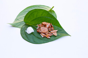 Chewing betel nut, Areca nut with cal lime powder on betel leaves