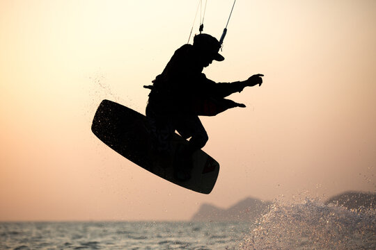 Kitesurfing, kiteboarding in exotic location, tropical island. Kitesurfer activities.