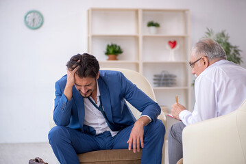 Fototapeta premium Young businessman employee visiting psychologist