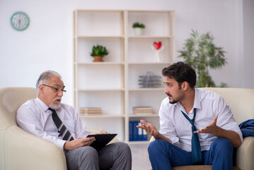 Fototapeta premium Young businessman employee visiting psychologist
