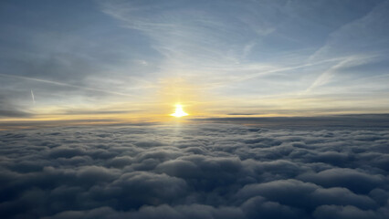 Beautiful sun shining over a thick layer of clouds