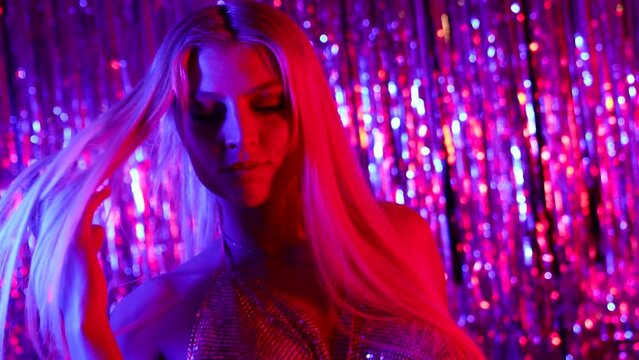 sexy go-go dancer is dancing in nightclub, seductive blonde woman