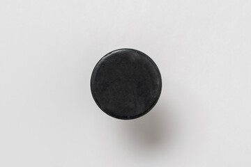hockey sport black rubber puck isolated close up view