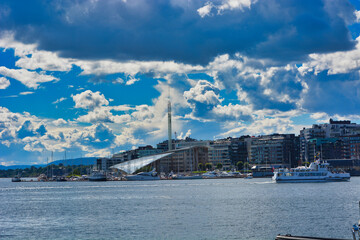 Scenic view of boats moored at the port against modern buildings in Oslo, Norway on a cloudy day - Powered by Adobe