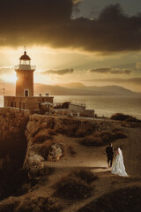 Vertical view of the married couple heading towards the Melagavi lighthouse in Jigsaw, Greece