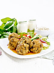 Meatballs with spinach and oatmeal on white board
