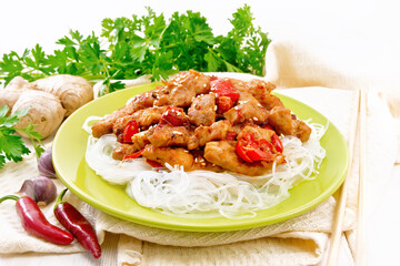 Stir-fry of chicken with peppers in plate on white board