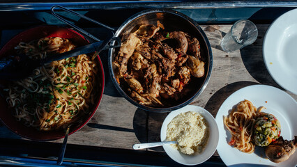 Closeup of Spaghetti and chicken cooked on a deck of a sailboat