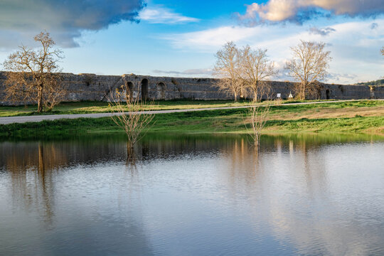 View from the lake to the stone walls of ancient city of Nicopolis in Greece