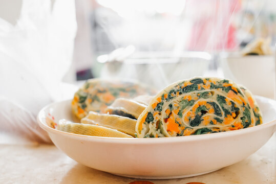 Close Up Shot Of Spinach Cheese Pinwheels In A White Bowl