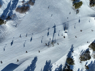 Ski lift seat on snowing mountain, cable way in ski resort.