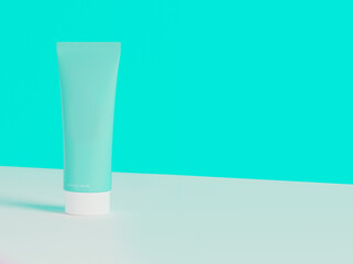 Lotion on table. Face or hand lotion on blue background. Blank cosmetic product.