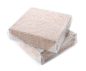 Cardboard boxes packed in bubble wrap on white background