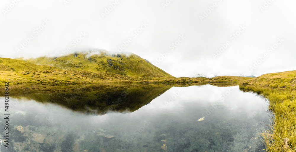 Sticker Beautiful shot of clouds covering lake and mountains