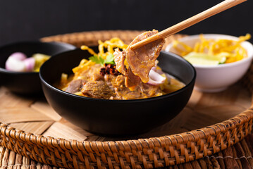 Northern Thai food (Khao Soi), Spicy curry noodles soup with coconut milk and beef, Local Thai food