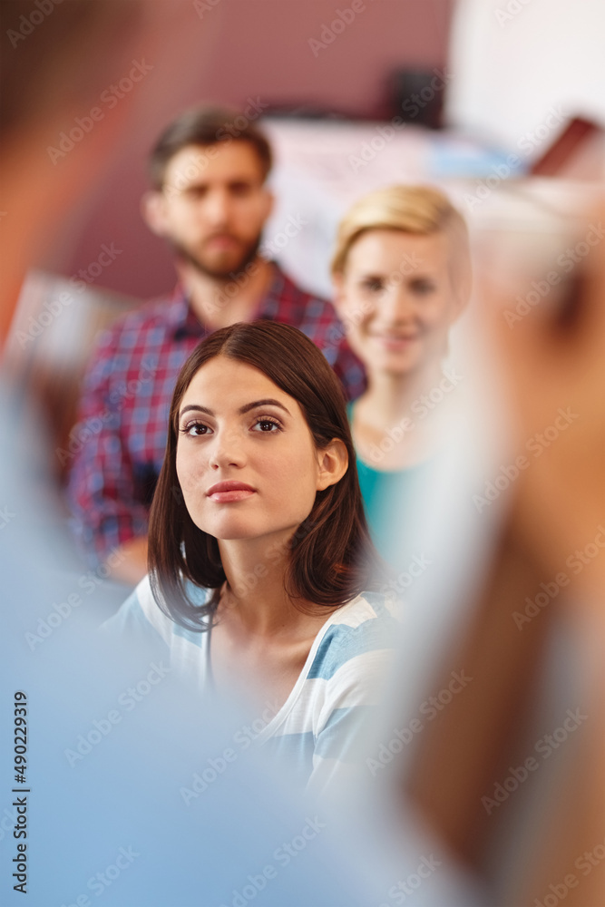 Poster always keep an open mind. shot of a group of coworkers listening to a presentation.