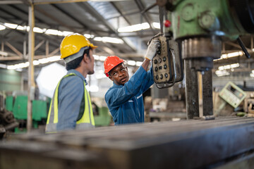 Professional asian workers and african man factory working at steel heavy machine. engineering...
