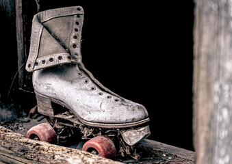 Closeup of a rusted old roller skate abandoned with dirt all around it