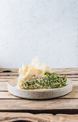 Vegetarian spinach pie with feta cheese on white wooden background. Traditional Greek spinach pie Spanakopita
