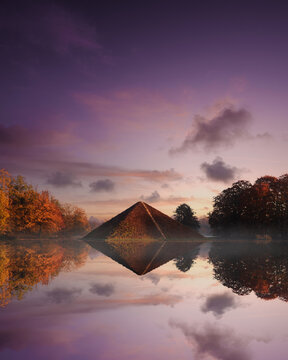 Vertical shot of a pyramid reflected in a pond in the Branitz Park, Cottbus, Germany