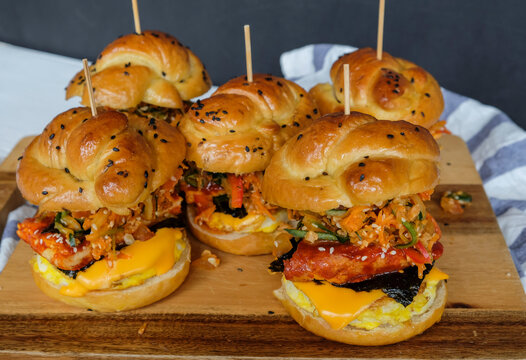 Delicious Homemade Pastry Meal. Pretzel Kimchi Burger. Made From Imported Kimchi In Tubs, Homemade Pretzel Dough, Cheese And Eggs In Spicy Korean Gochujang Sauce.