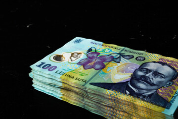 Closeup shot of a 100 leu banknotes stack isolated on black background
