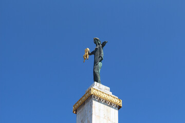 Low angle shot of the Sculptured Statue of Medea in Batumi, Georgia against a blue sky - obrazy, fototapety, plakaty