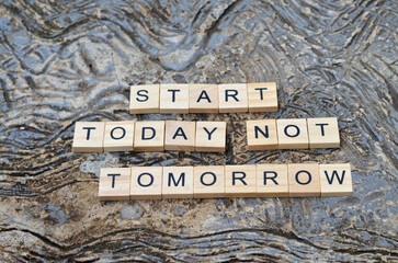 start today not tomorrow text on wooden square, business and motivation quotes