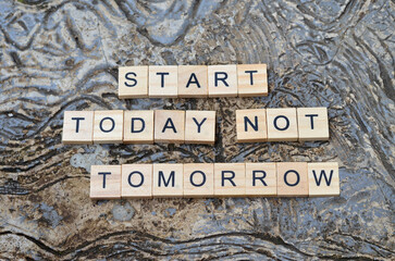 start today not tomorrow text on wooden square, business and motivation quotes