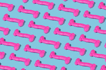 A pattern of red rubber bones of dog toys on a blue background.
