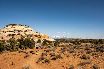 Hiker Walking Along Tail To The Aztec Buttes