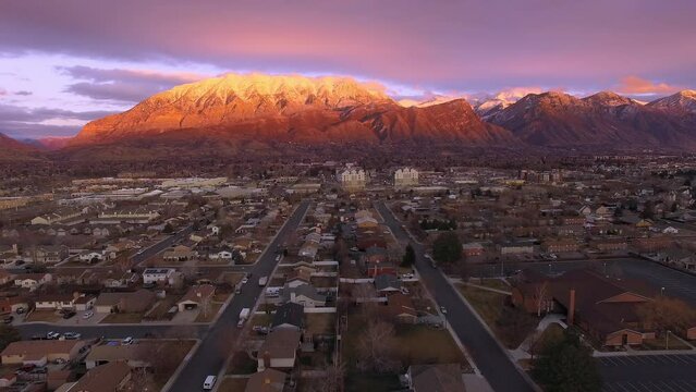 Aerial view of Orem City during sunset in Utah viewing streets and houses in the valley.