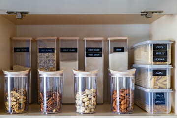 Domestic healthy vegetarian dry food storage organization on shelf at kitchen cupboard