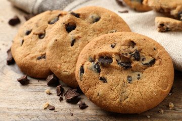 Delicious chocolate chip cookies on wooden table, closeup