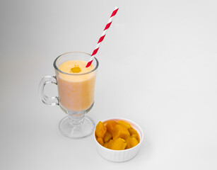 Yellow Indian mango yoghurt drink Mango Lassi or smoothie with turmeric and saffron.